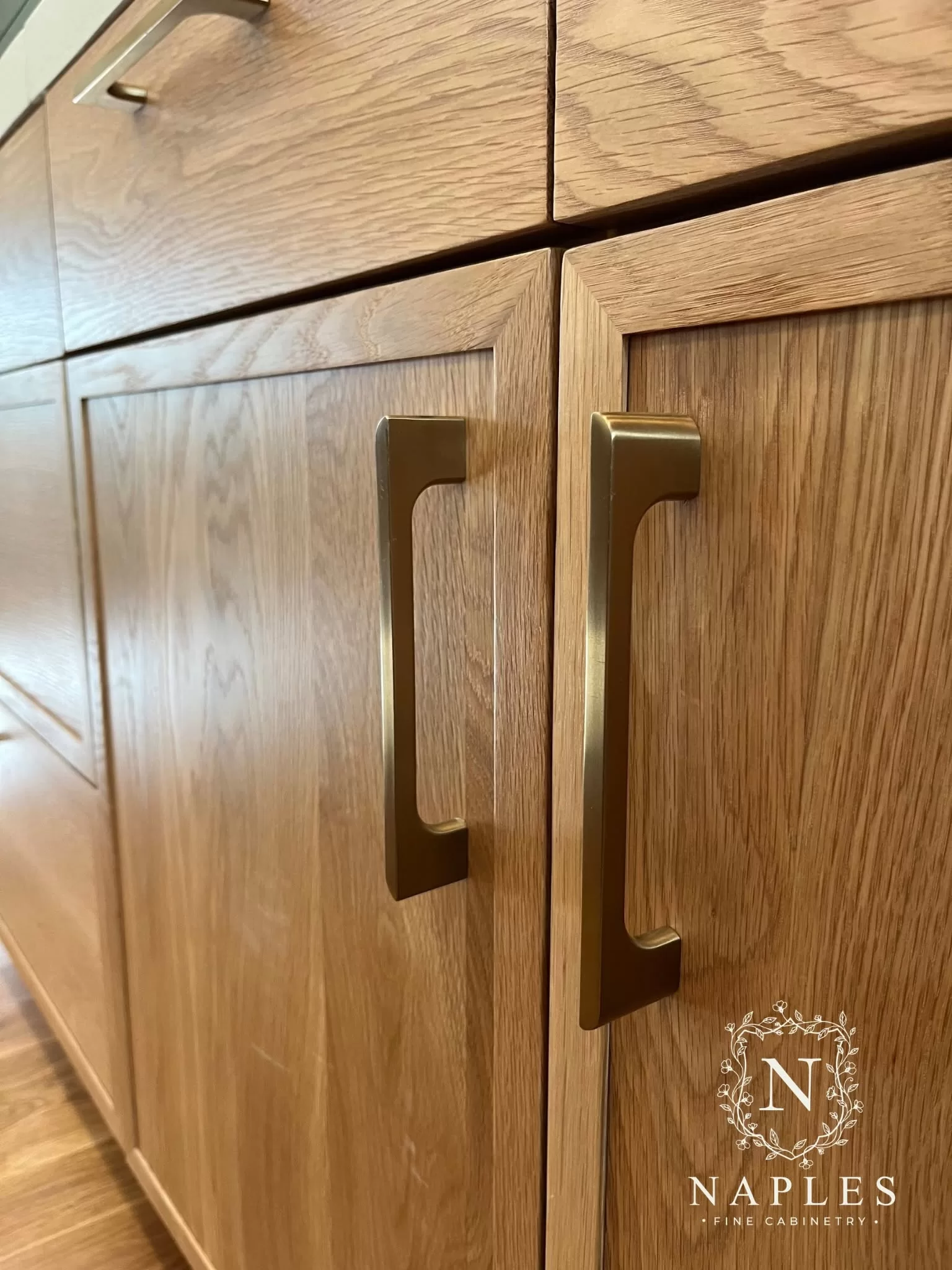 Natural oak cabinetry and brushed brass handles